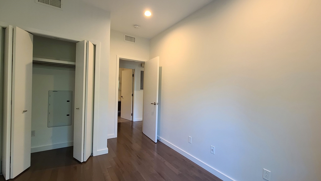 143-171 Hyde Park Avenue, Unit 163B Boston, MA 02130 - Photo 16 of 24 a view of a hallway with wooden floor