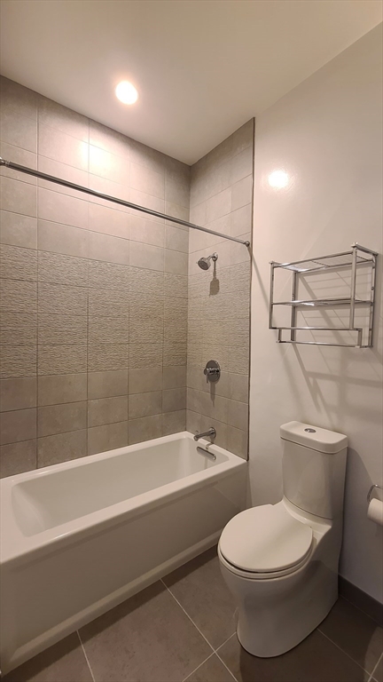 143-171 Hyde Park Avenue, Unit 163B Boston, MA 02130 - Photo 18 of 24 a bathroom with a toilet and a bath tub