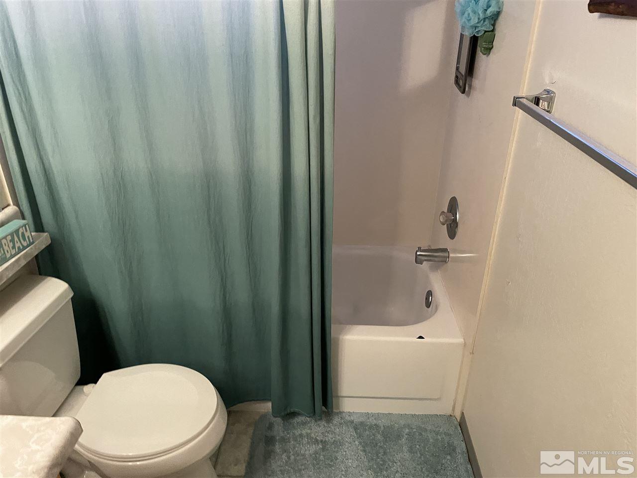 1088 Embassy Way Reno, NV 89523 - Photo 8 of 12 a white toilet sitting next to a bathroom sink