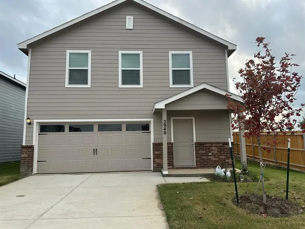 a front view of a house with a garage