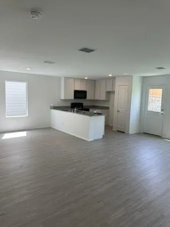 a kitchen with stainless steel appliances a refrigerator and a stove top oven