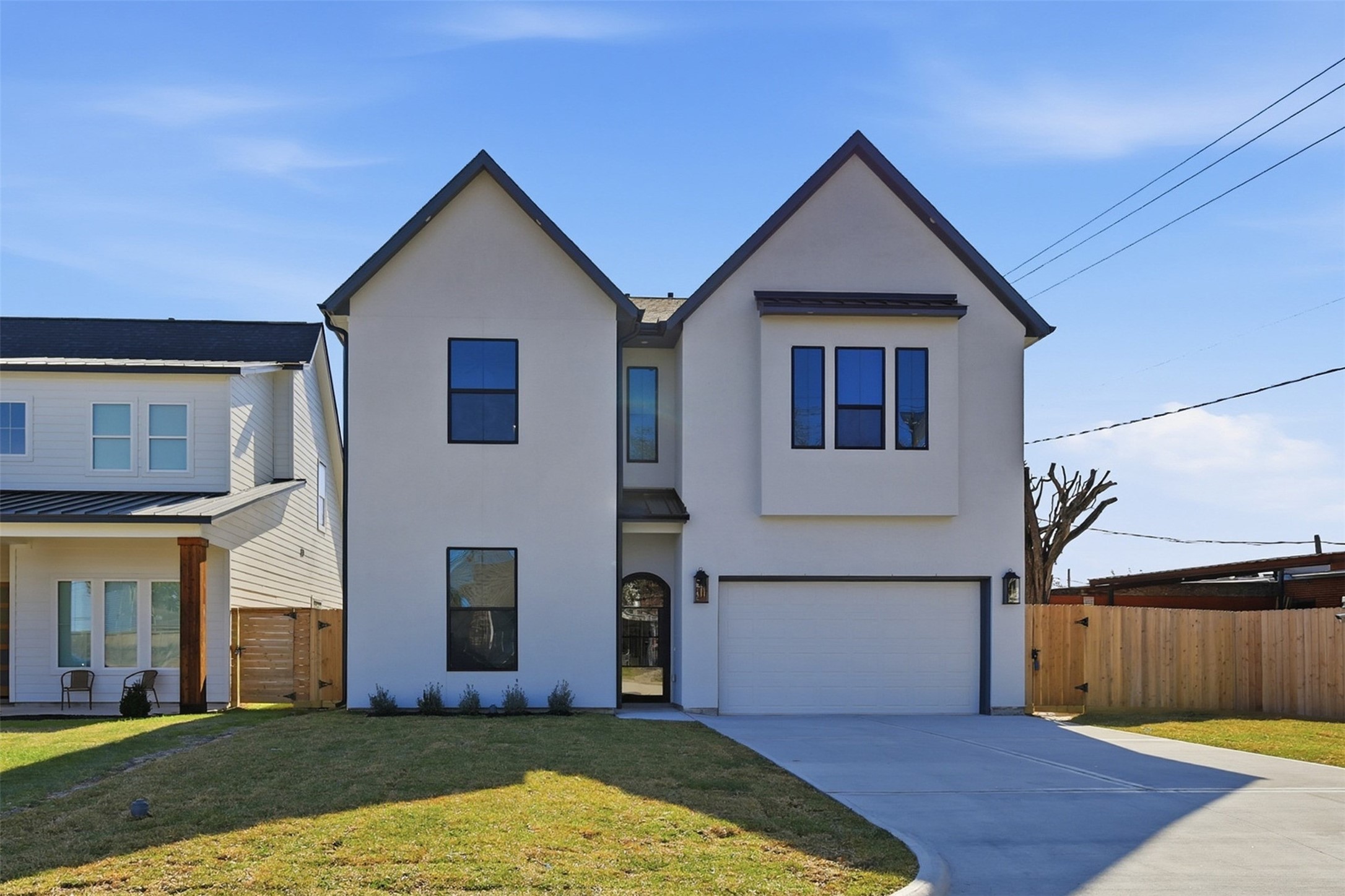 The home’s clean stucco exterior and subtle soffit lighting highlight its’ modern architecture and thoughtful detailing, offering a warm and welcoming presence from the street.