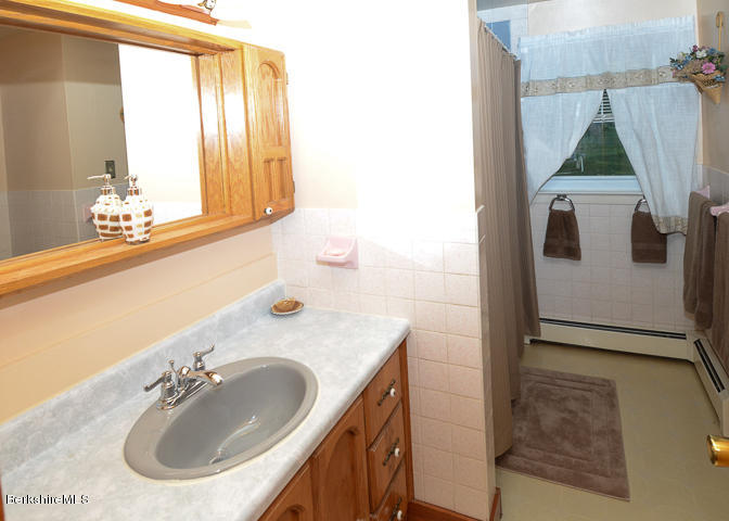 3759 Hancock Road Hancock, MA 01237 - Photo 23 of 30 a bathroom with a sink vanity and mirror