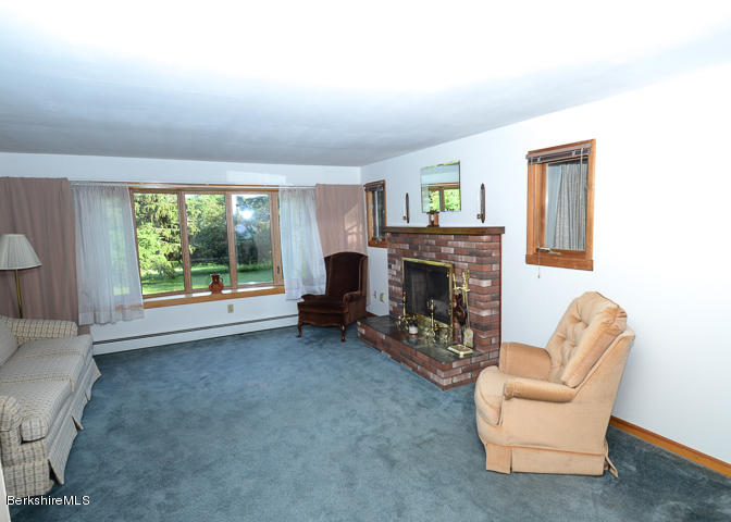 3759 Hancock Road Hancock, MA 01237 - Photo 5 of 30 a living room with furniture and a fireplace