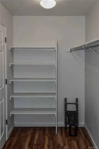 a view of walk in closet with empty racks
