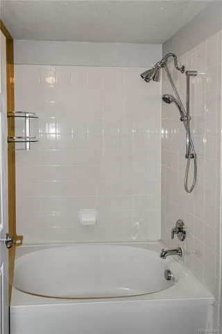 a bathroom with a shower and a bath tub