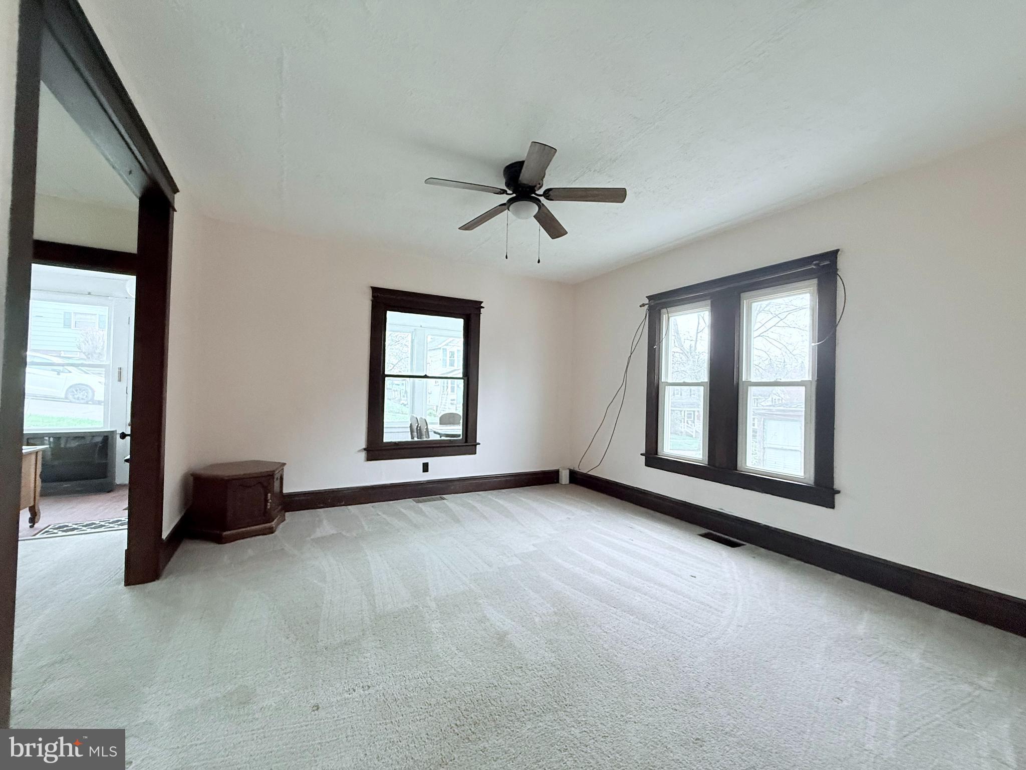 439 Bayard Street Kane, PA 16735 - Photo 6 of 22 a view of a livingroom with a ceiling fan and windows
