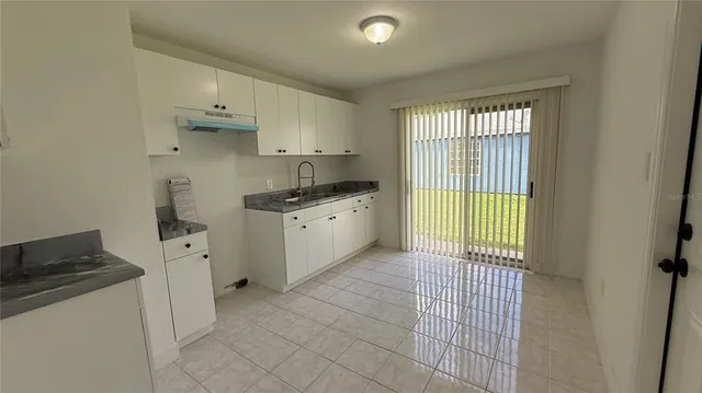 a kitchen with stainless steel appliances a sink stove and cabinets