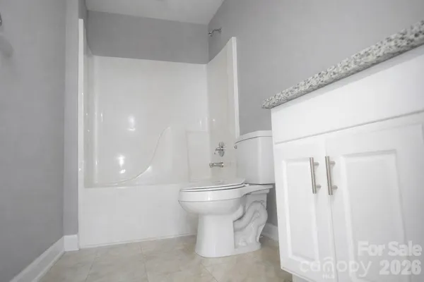 a white toilet sitting next to a bathroom sink