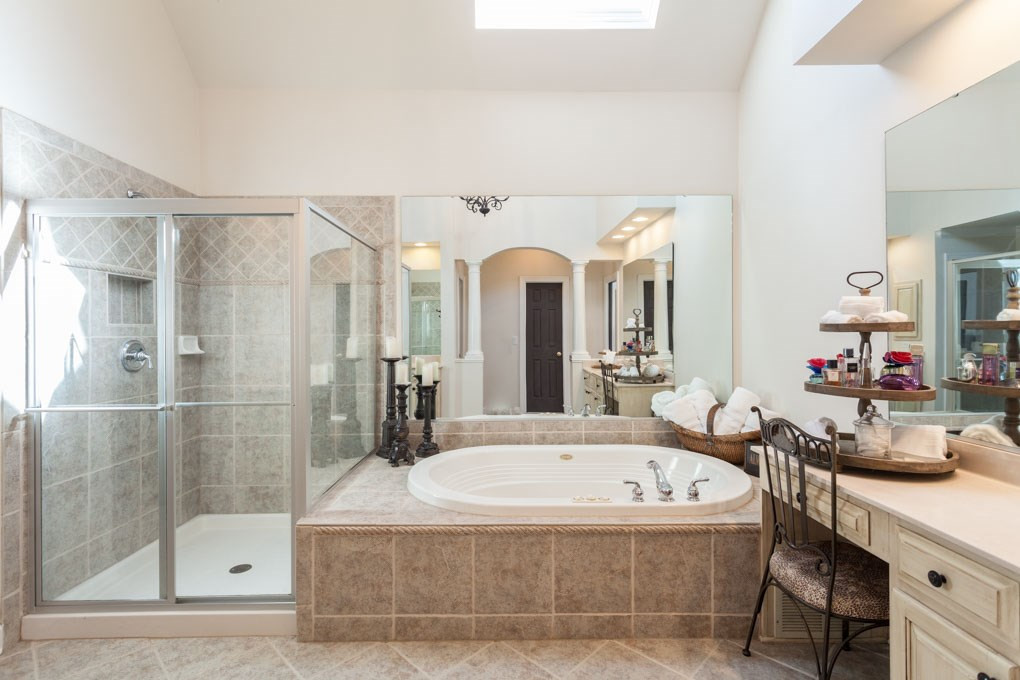 12340 Canolder Street Raleigh, NC 27614 - Photo 15 of 30 The large master bath offers a jetted tub, large walk-in shower with tile surround, 2 separate vanities, linen closet and private water closet(toilet room). Well-Appointed Master Bath