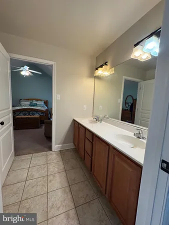 a spacious bathroom with a double vanity sink and a mirror