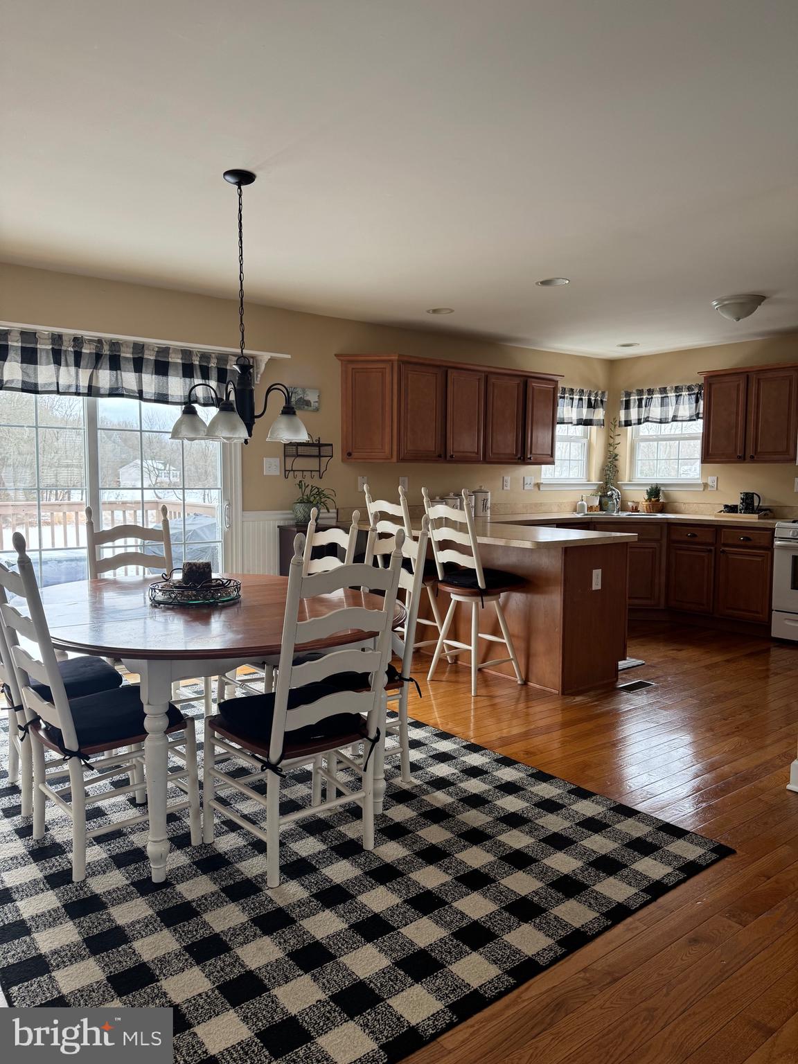 5432 Lake Road Newfield, NJ 08344 - Photo 2 of 24 a kitchen with stainless steel appliances kitchen island granite countertop a sink and a table