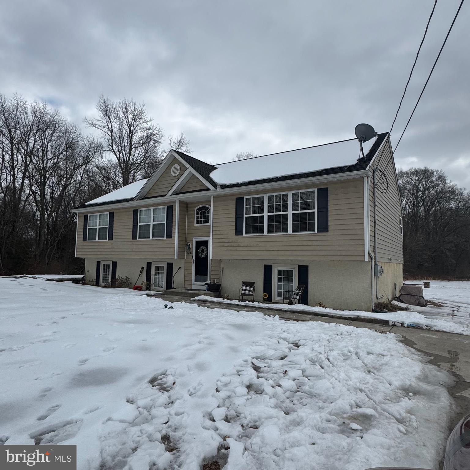 5432 Lake Road Newfield, NJ 08344 - Photo 22 of 24 a front view of a house with a yard covered in snow