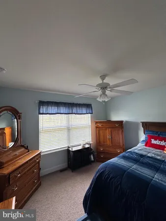 a bedroom with a bed and a television