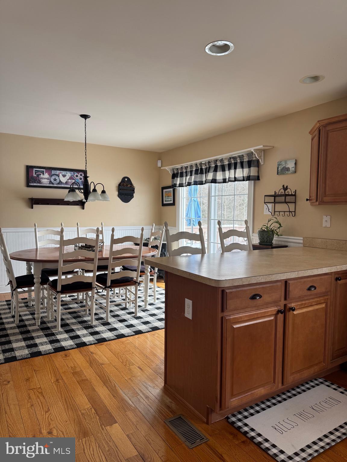 5432 Lake Road Newfield, NJ 08344 - Photo 4 of 24 a view of living room with kitchen island stainless steel appliances and wooden floor