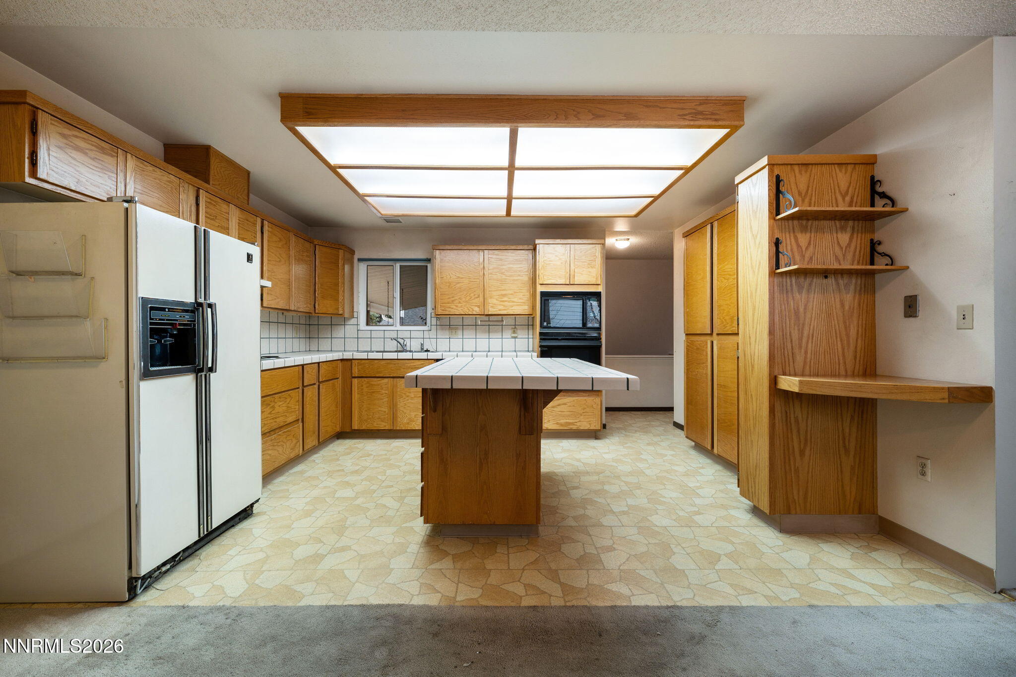 2685 Everett Drive Reno, NV 89503 - Photo 3 of 40 a large kitchen with stainless steel appliances kitchen island granite countertop a refrigerator and a sink