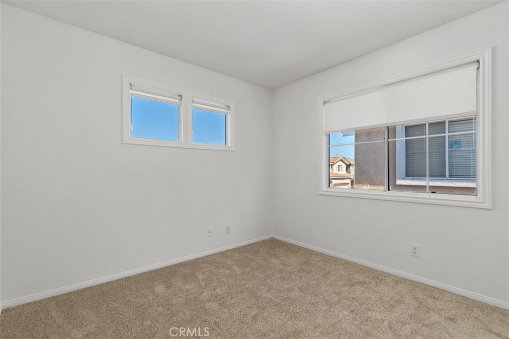 56 Acorn Ridge Rancho Santa Margarita, CA 92688 - Photo 36 of 57 Secondary Bedroom: Bright bedroom with neutral carpeting and multiple windows that bring in natural light.