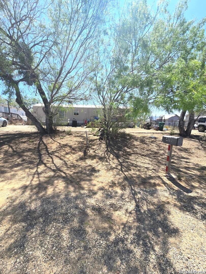 408 Hickory Street Jourdanton, TX 78026 - Photo 2 of 9 a view of a outdoor space with a tree