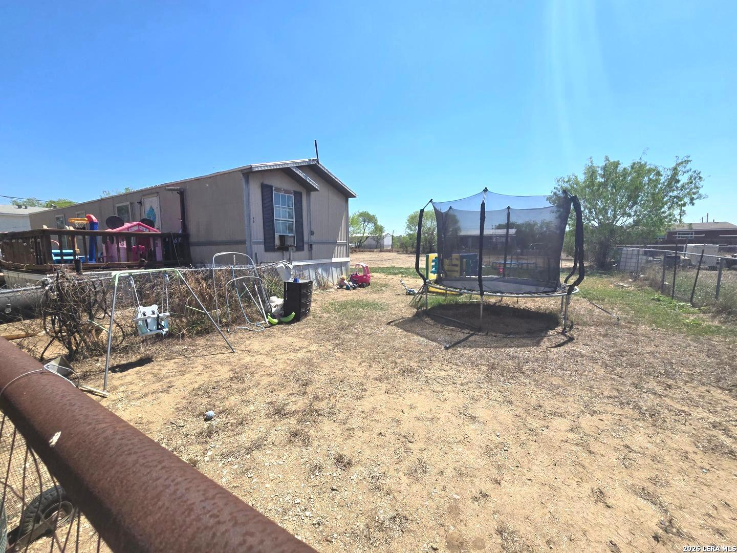 408 Hickory Street Jourdanton, TX 78026 - Photo 9 of 9 a view of roof deck with a barbeque and wooden fence