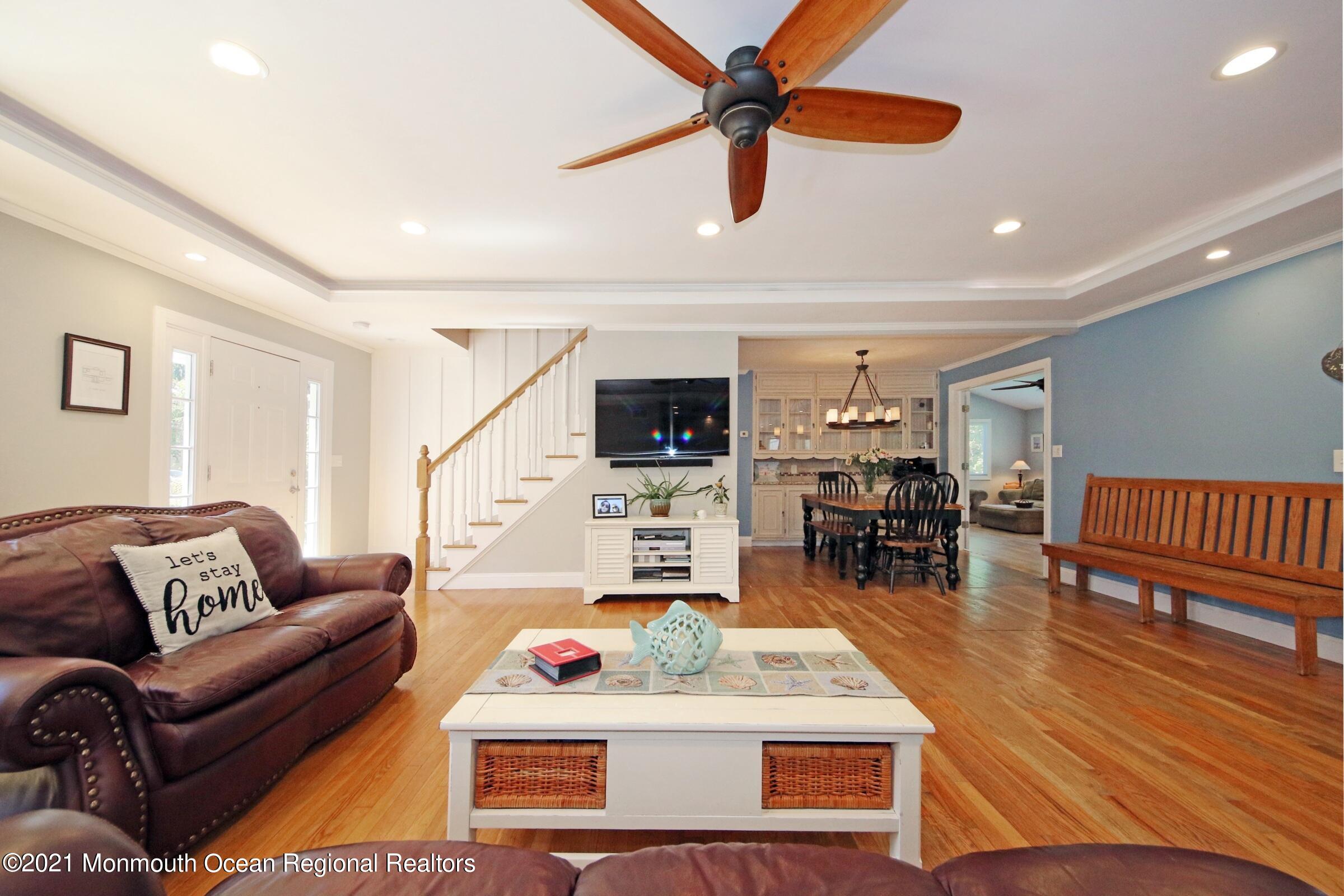 27 Demmert Avenue Rumson, NJ 07760 - Photo 1 of 38 a living room with furniture and a flat screen tv with wooden floor
