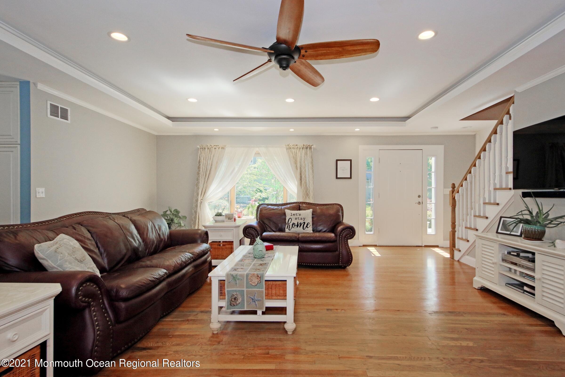 27 Demmert Avenue Rumson, NJ 07760 - Photo 2 of 38 a living room with furniture flat screen tv and wooden floor