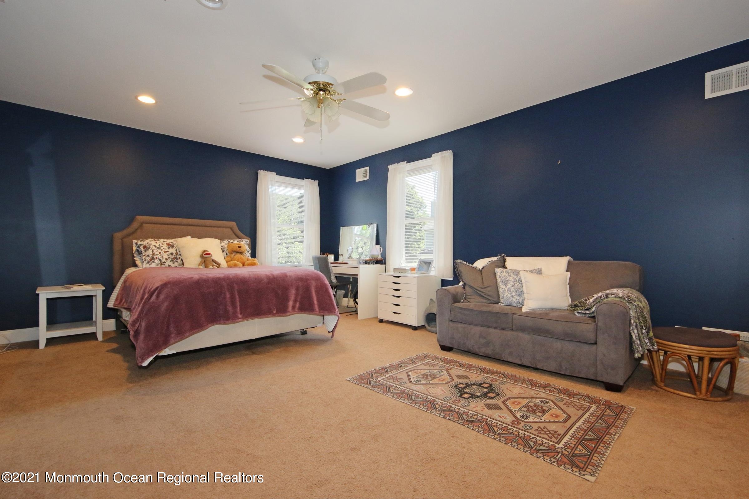 27 Demmert Avenue Rumson, NJ 07760 - Photo 12 of 38 a bedroom with a bed couch and window