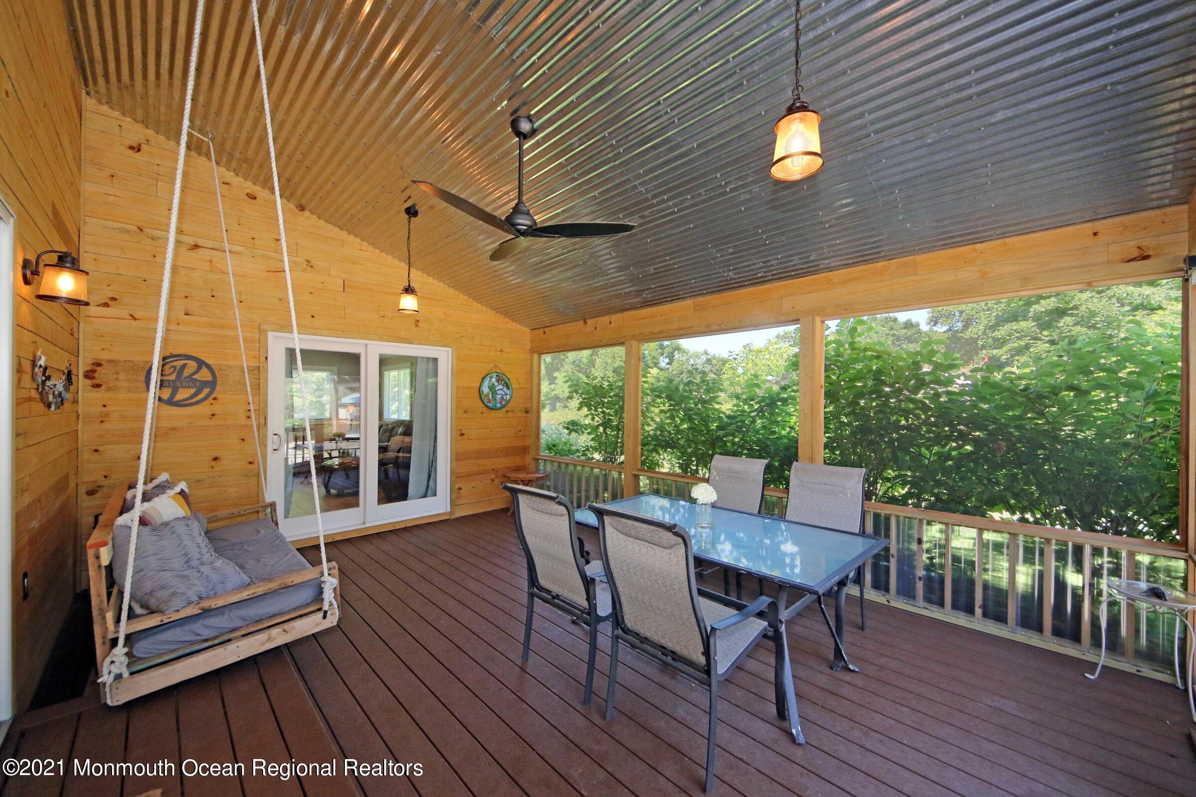 27 Demmert Avenue Rumson, NJ 07760 - Photo 18 of 38 a view of a patio with a table chairs and wooden floor