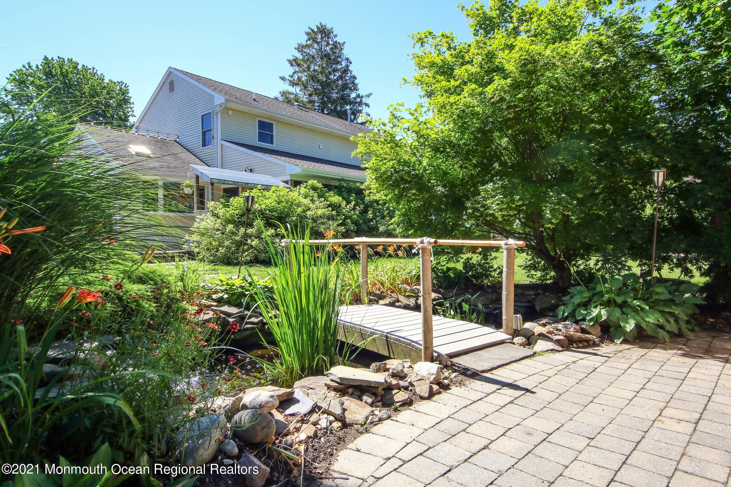 27 Demmert Avenue Rumson, NJ 07760 - Photo 22 of 38 a view of a chairs and tables in the backyard