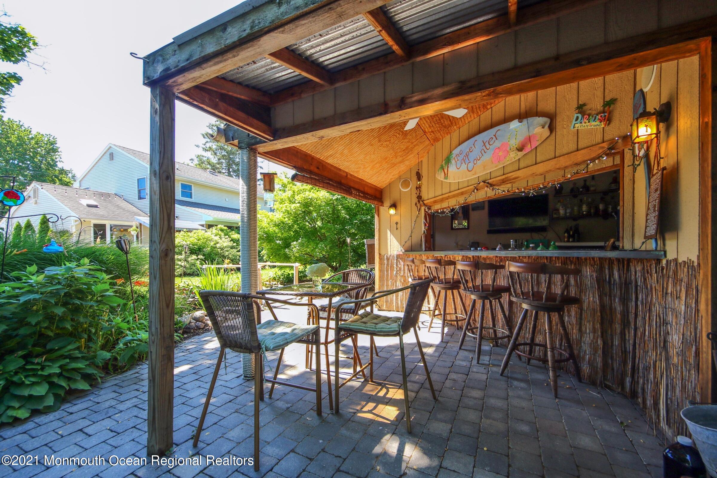 27 Demmert Avenue Rumson, NJ 07760 - Photo 25 of 38 a view of an outdoor space with a table and chairs