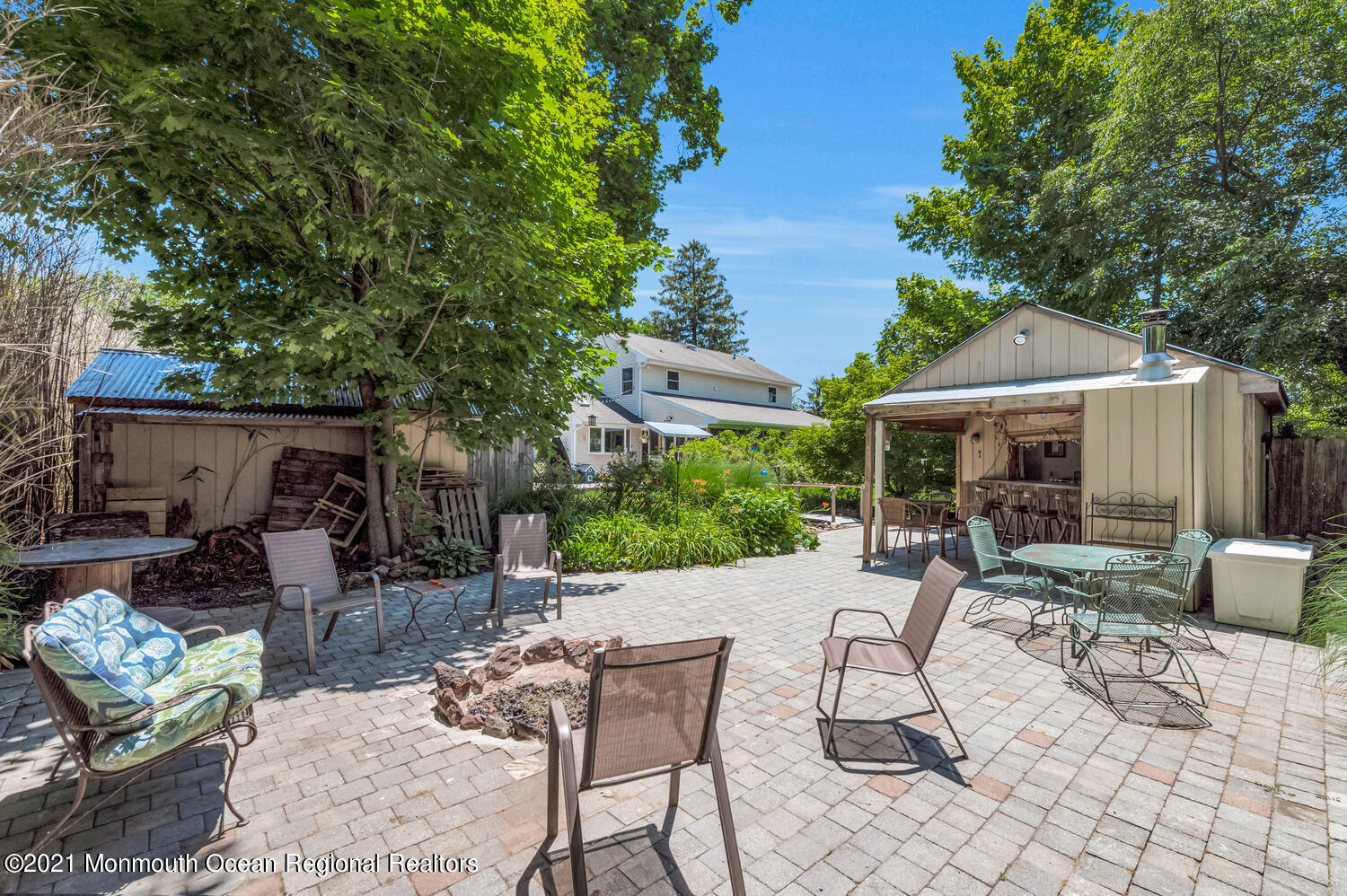 27 Demmert Avenue Rumson, NJ 07760 - Photo 26 of 38 a view of a patio with table and chairs potted plants and a large tree