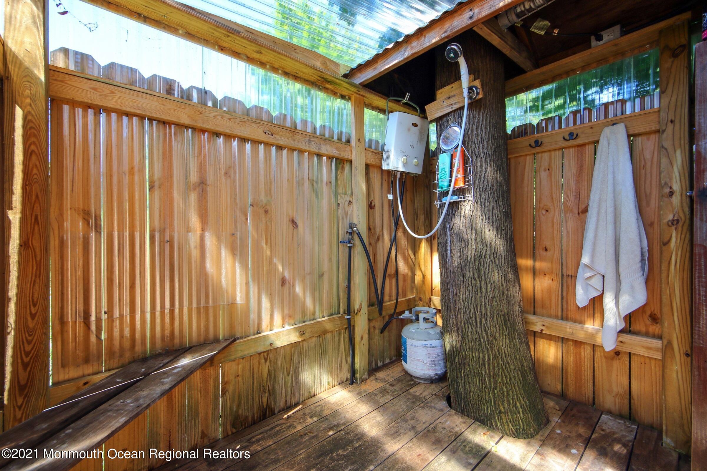 27 Demmert Avenue Rumson, NJ 07760 - Photo 28 of 38 a view of a backyard with a wooden fence