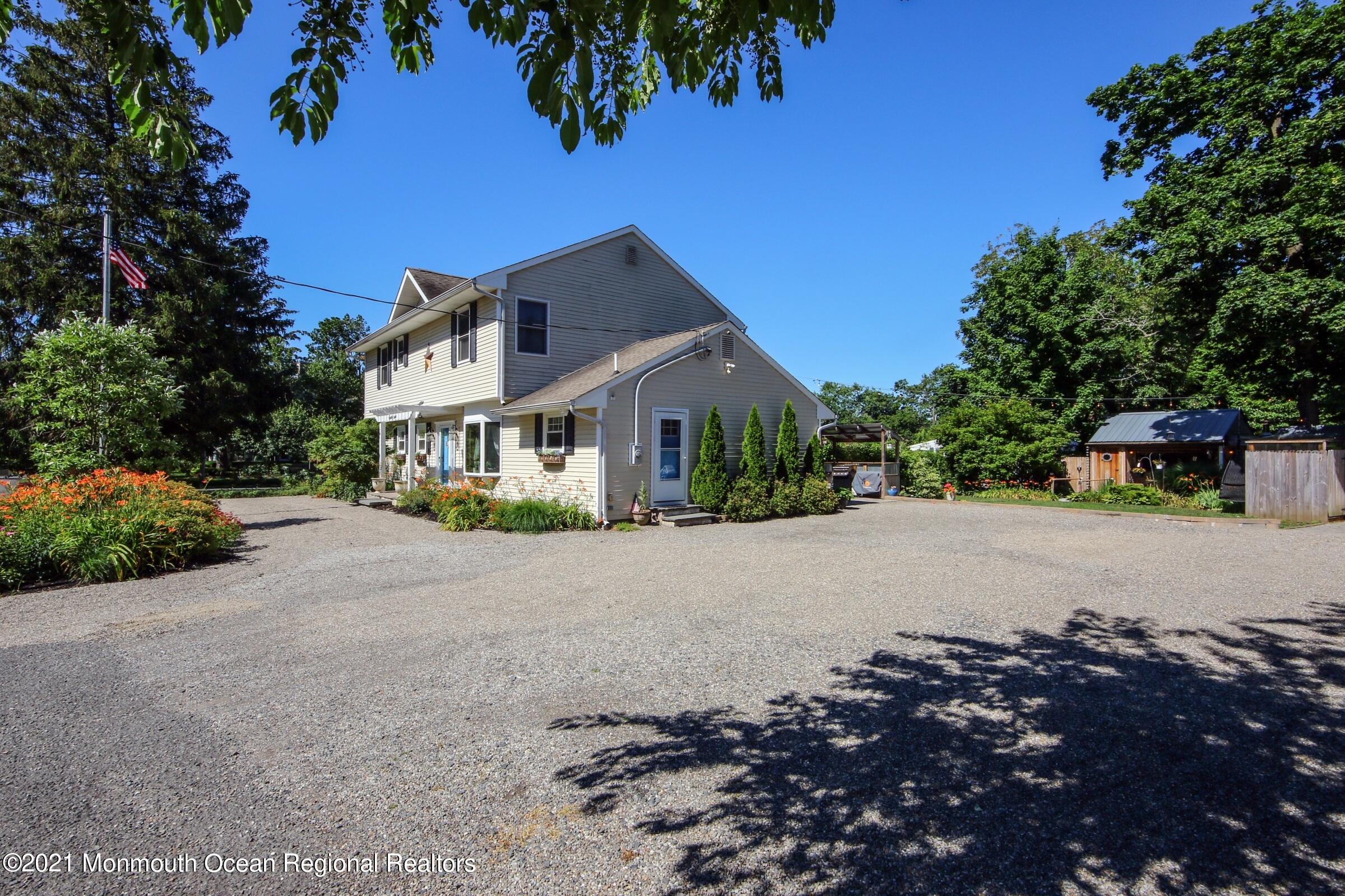 27 Demmert Avenue Rumson, NJ 07760 - Photo 29 of 38 a front view of a house with a yard and garage