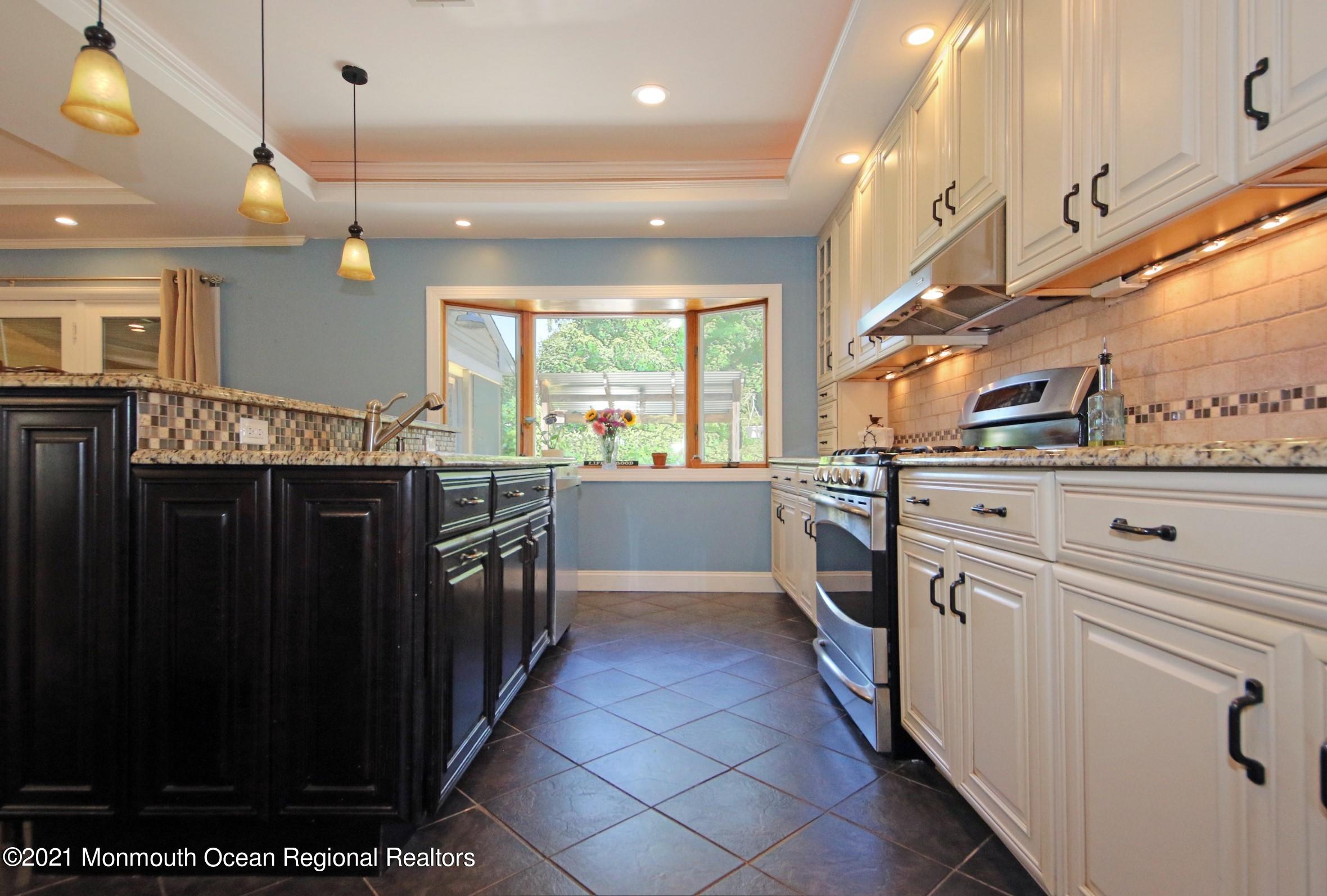 27 Demmert Avenue Rumson, NJ 07760 - Photo 4 of 38 a kitchen with stainless steel appliances a stove a sink and a refrigerator