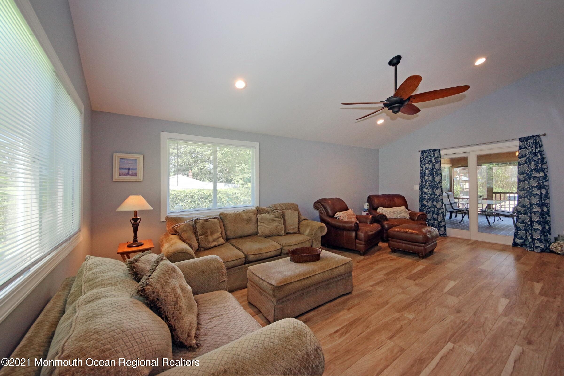 27 Demmert Avenue Rumson, NJ 07760 - Photo 7 of 38 a living room with furniture a window and a flat screen tv