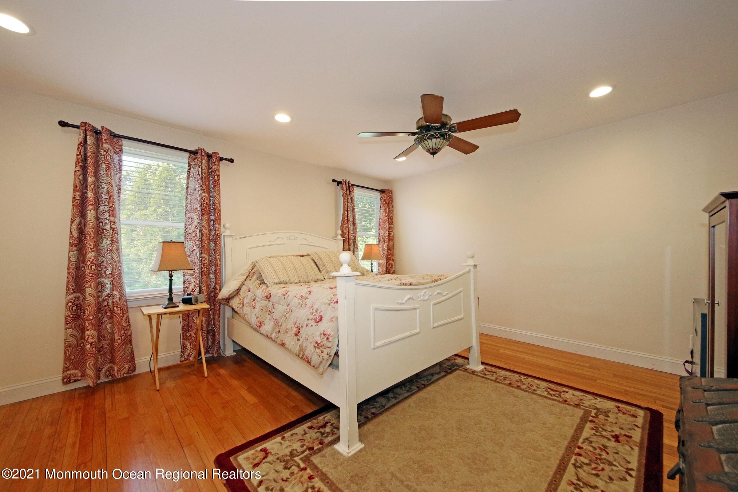 27 Demmert Avenue Rumson, NJ 07760 - Photo 8 of 38 a room with a bed and a ceiling fan
