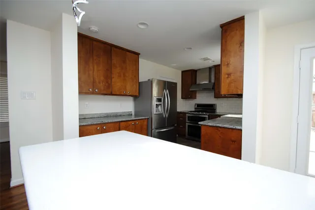 a kitchen with stainless steel appliances a refrigerator stove and sink