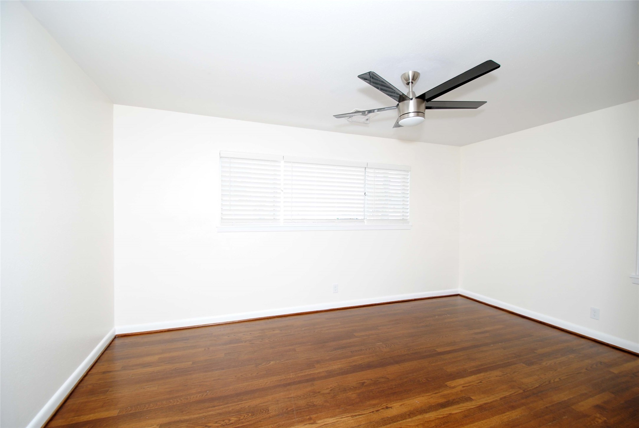 7953 Ridgeview Drive Houston, TX 77055 - Photo 22 of 29 a view of a room with wooden floor and a ceiling fan