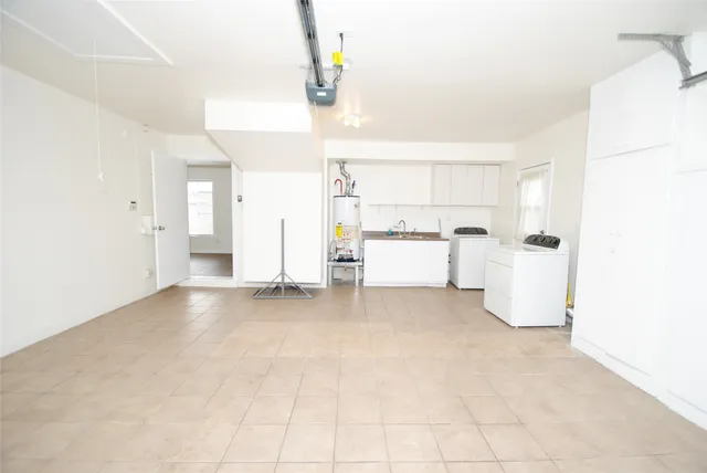 a view of a kitchen with a sink and dishwasher white cabinet with wooden floor