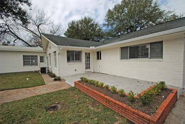 a view of a yard with wooden fence