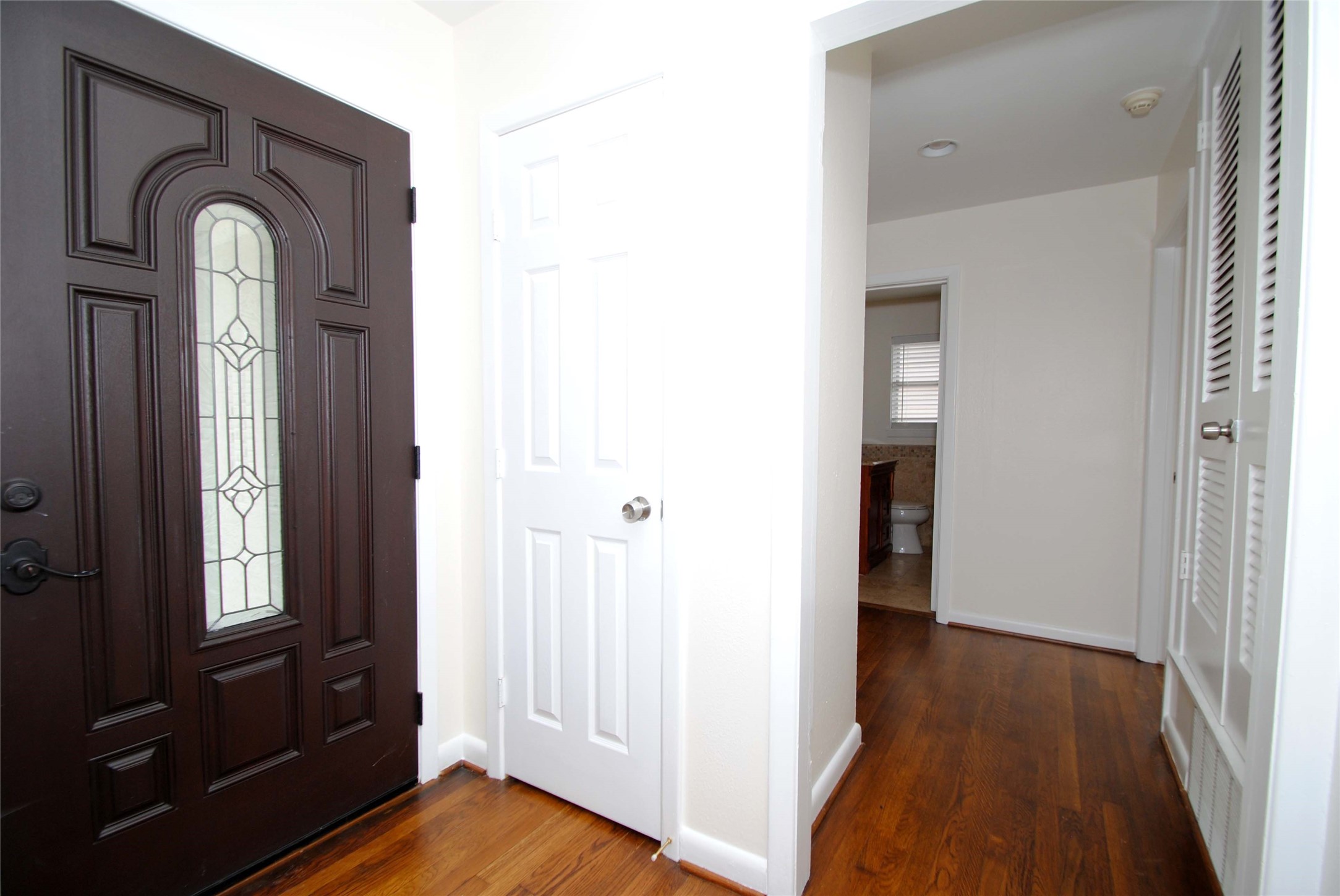 7953 Ridgeview Drive Houston, TX 77055 - Photo 5 of 29 a view of front door with hallway and wooden floor