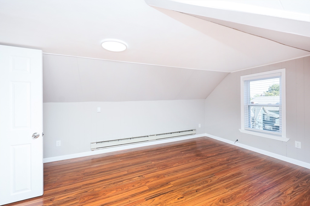 15-17 Saunders Street, Unit 15 Boston, MA 02134 - Photo 17 of 22 an empty room with wooden floor and windows