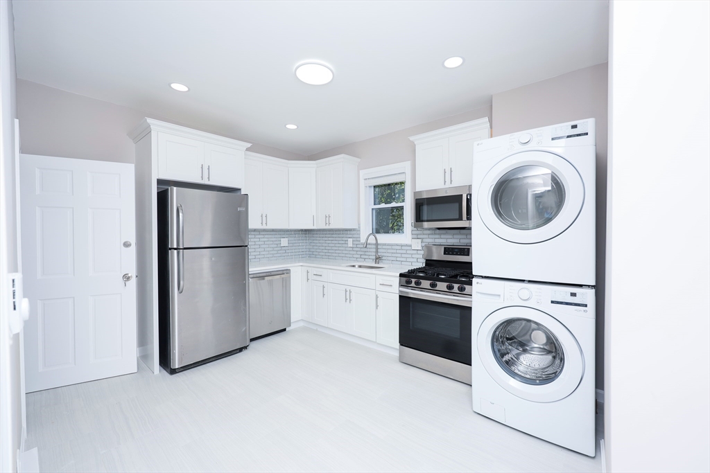 15-17 Saunders Street, Unit 15 Boston, MA 02134 - Photo 2 of 22 a view of kitchen and washer and dryer