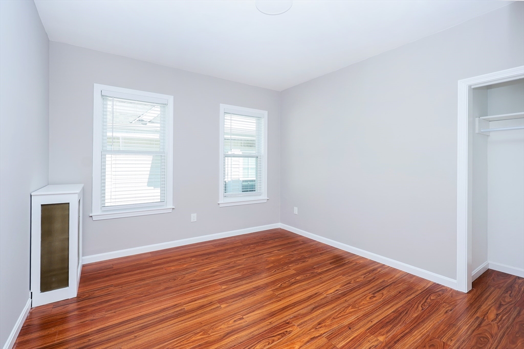 15-17 Saunders Street, Unit 15 Boston, MA 02134 - Photo 5 of 22 an empty room with wooden floor and windows