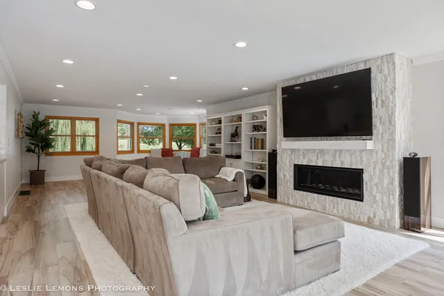 a large white kitchen with lots of counter top space and living room