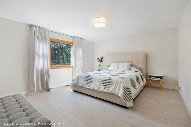 a spacious bathroom with a double vanity sink a mirror and a bathtub