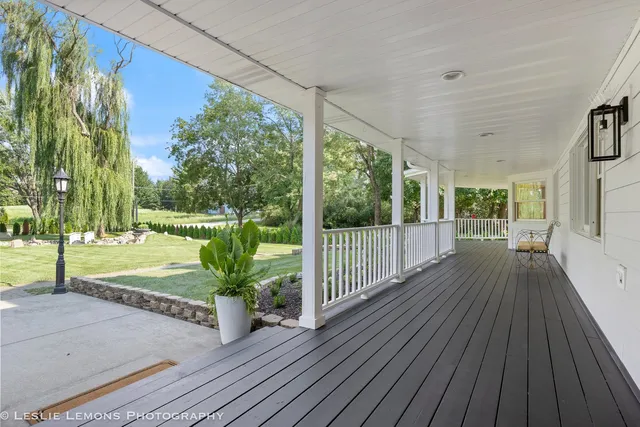 a view of a house with backyard and wooden floor