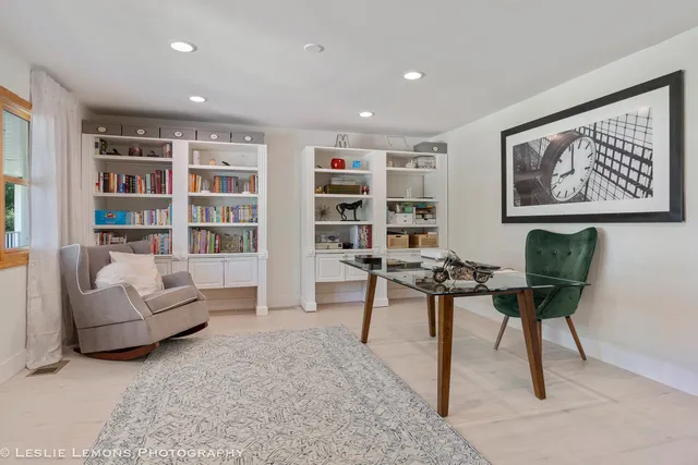 a large kitchen with stainless steel appliances granite countertop a large counter top a stove and a refrigerator with wooden floor