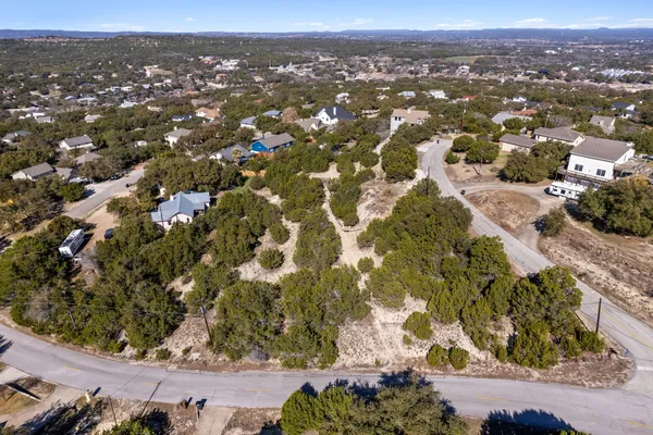 an aerial view of residential houses with city view