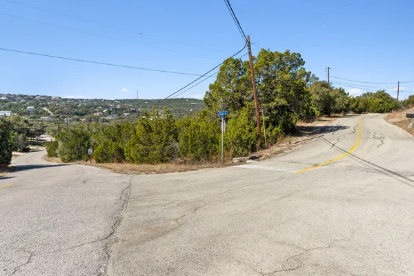 a view of a road with a building in the background