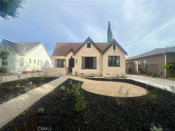 a front view of a house with yard outdoor seating and barbeque oven